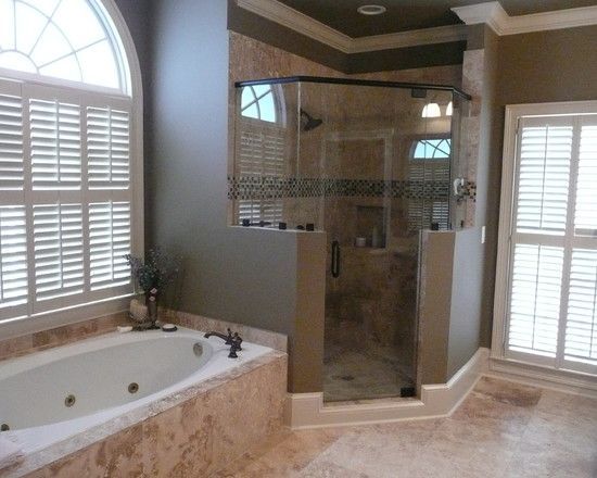 A bathroom with a tub and a walk in shower