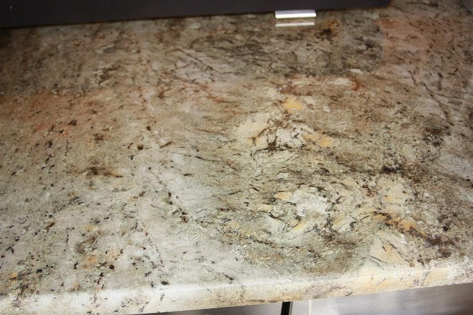 A close up of a granite counter top in a kitchen