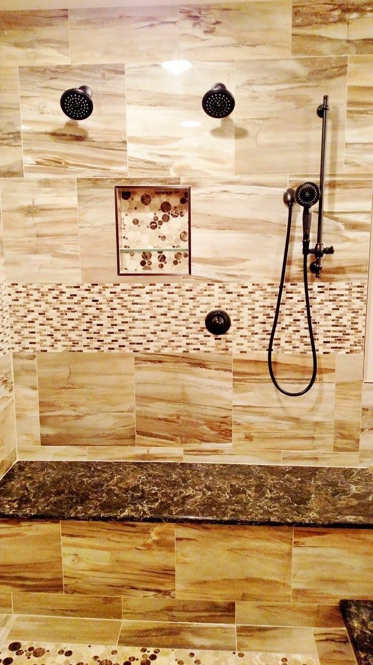 A bathroom with a walk in shower and a granite counter top.