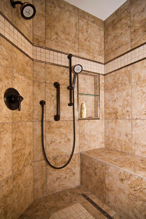 There is a shower with a bench and a shower head.