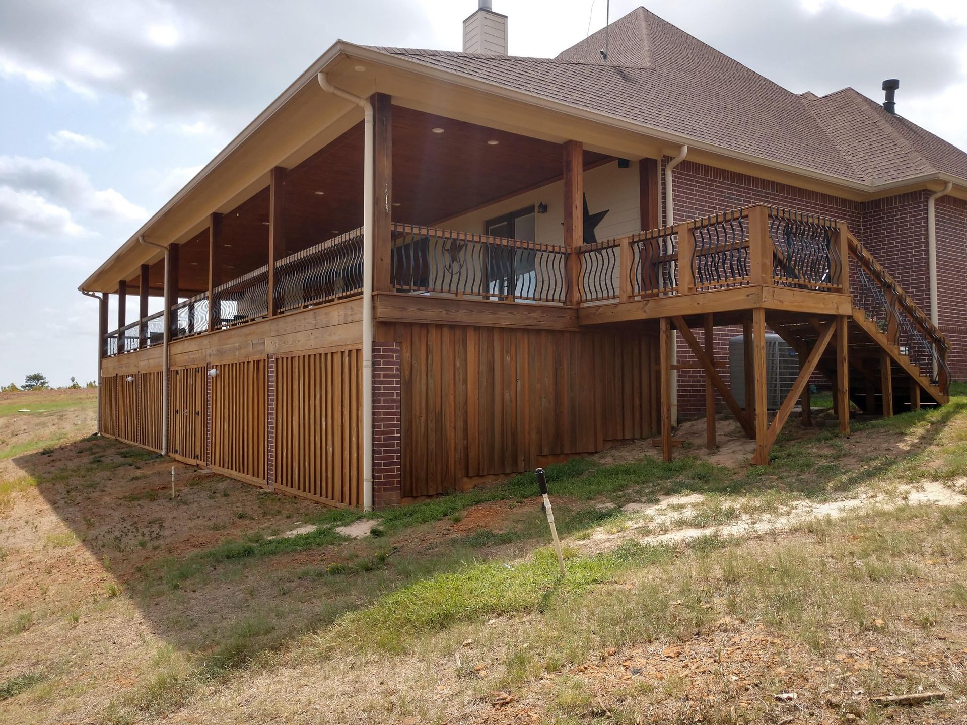 A large house with a large deck and stairs.