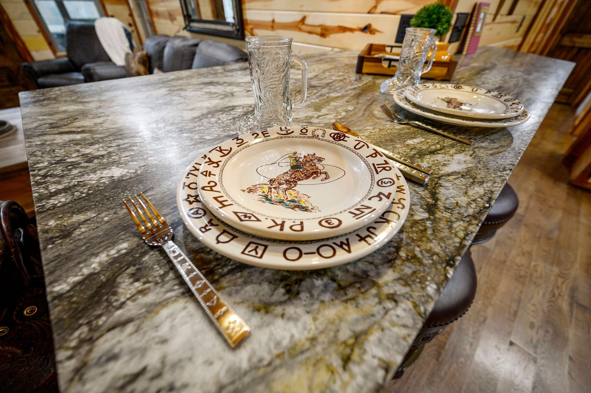 A place setting with a decorative patterned plate and fork on a polished stone countertop in a rustic living area.