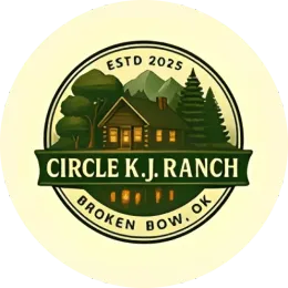 A circular logo for Circle K.J. Ranch in Broken Bow, OK, featuring a cabin, mountains, and trees in green and cream tones.