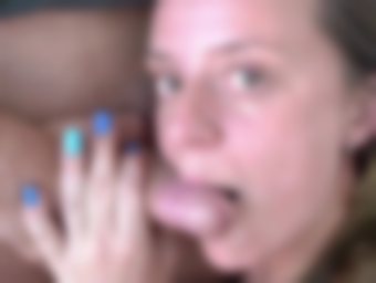 Woman with blue nails sticks out her tongue near another person's body; their hand is near the person's body.