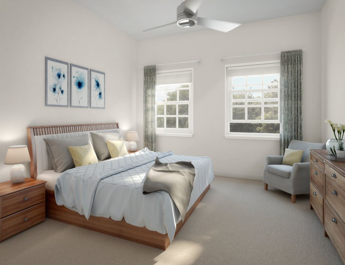 A bedroom with a bed, dresser, chair, and ceiling fan at Arden at Pooler.