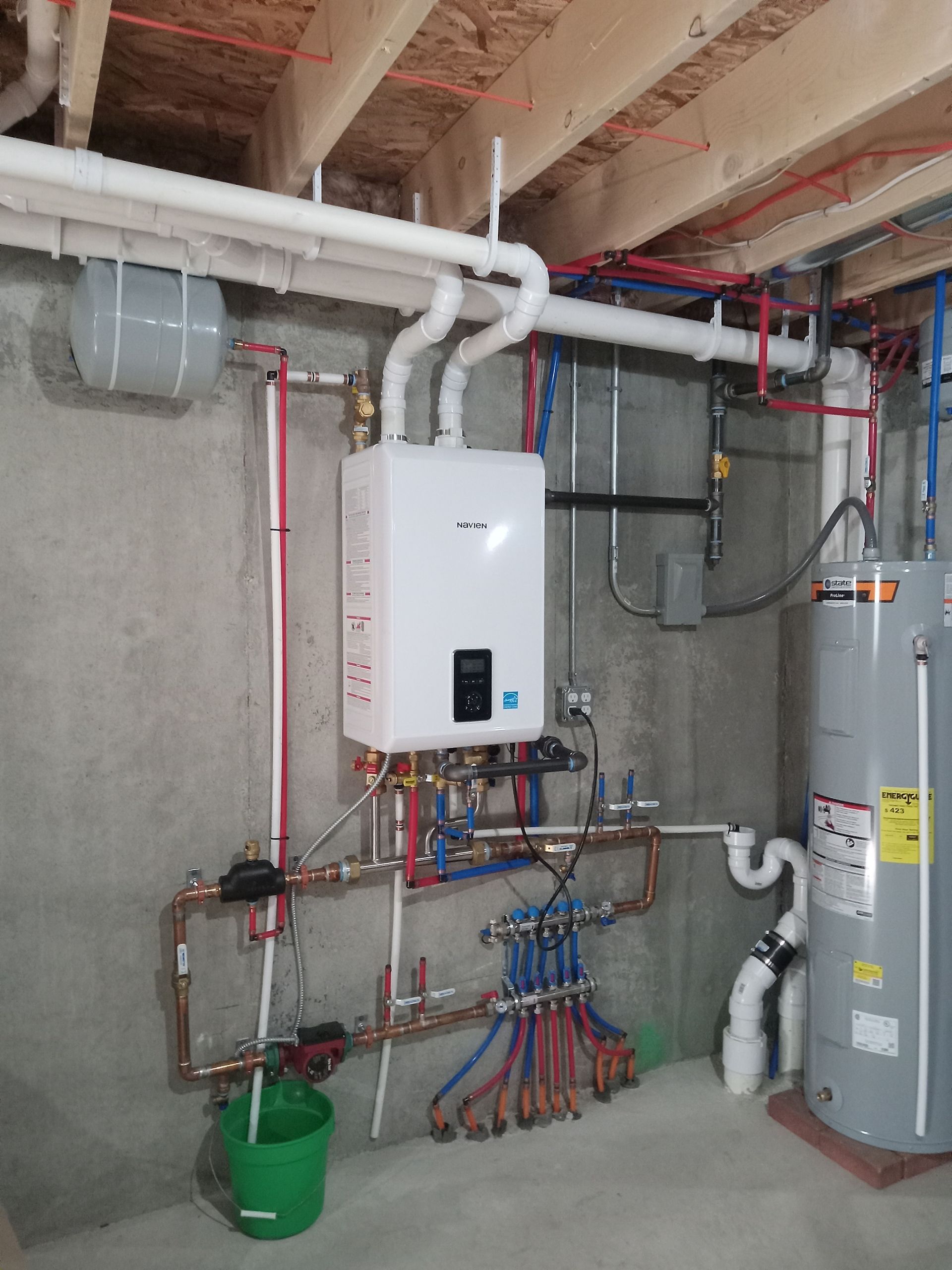 Installation of radiant floor heat boiler in the basement of new construction.