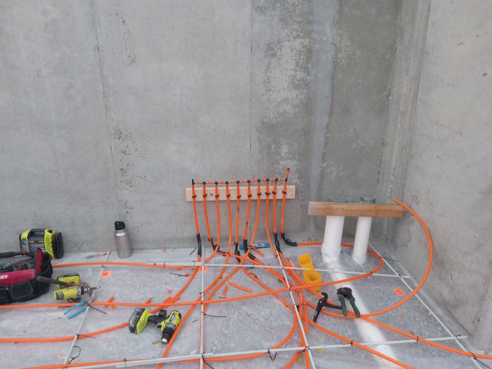 Installation of radiant floor heat tubing in the basement of new construction.