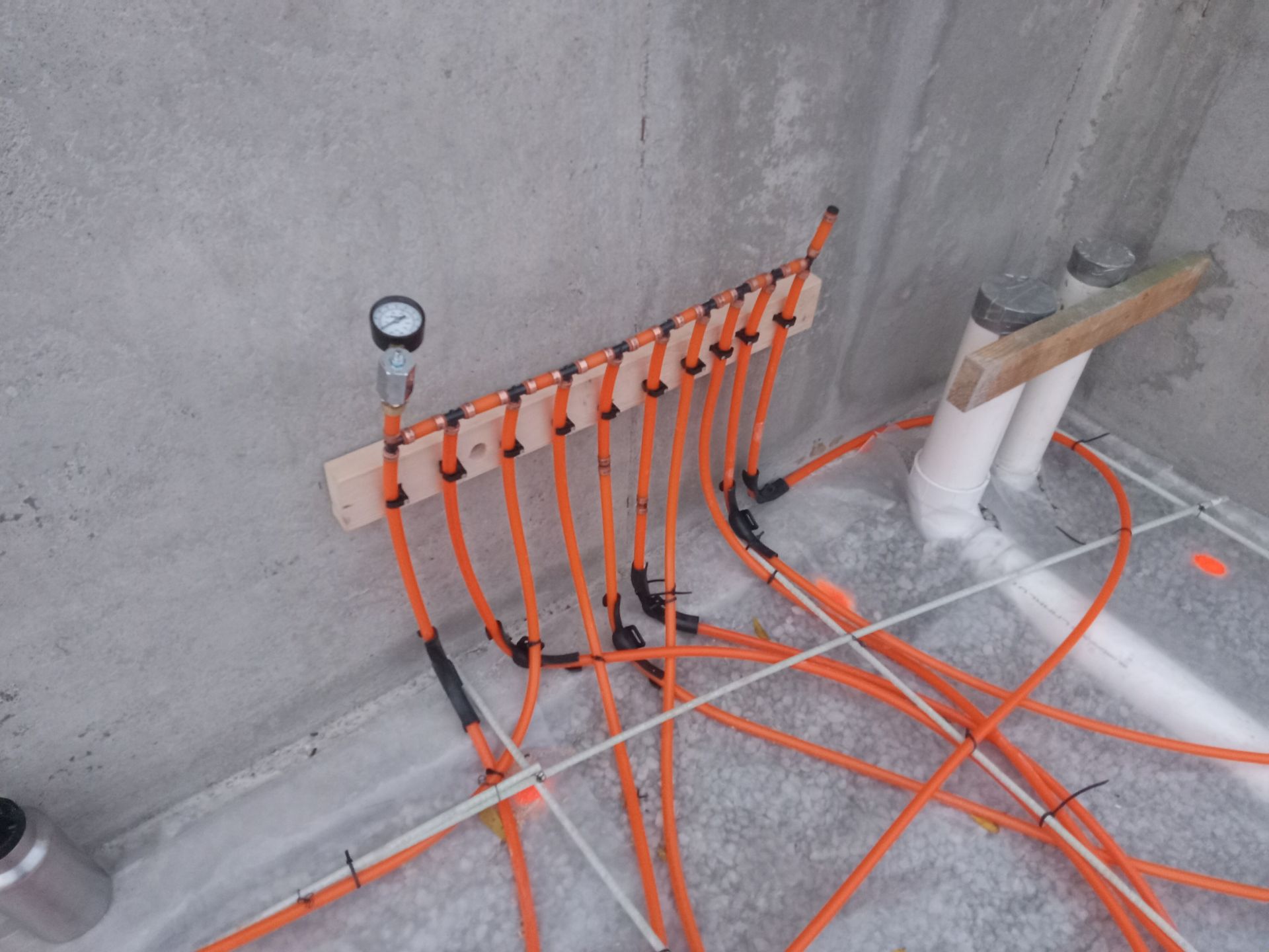 Installation of radiant floor heat tubing in the basement of new construction.