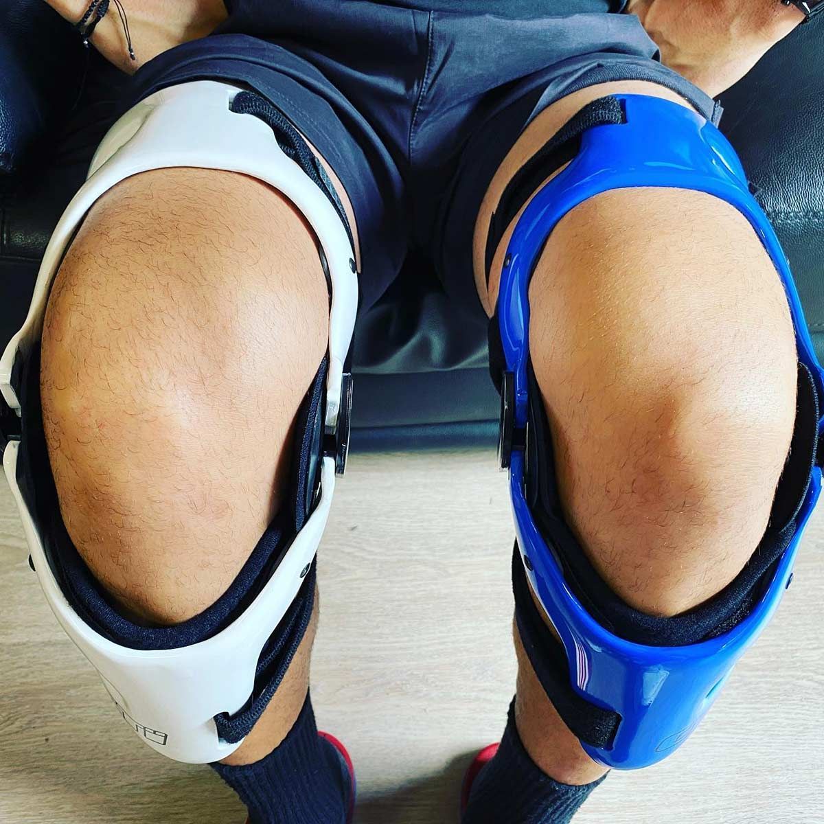 A Person Wearing Knee Braces is Sitting on a Couch — Gall Bros Medical in Adelaide, SA