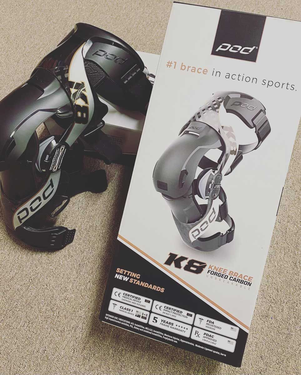 A Pair of Knee Braces Sitting Next to a Box — Gall Bros Medical in Robina, QLD