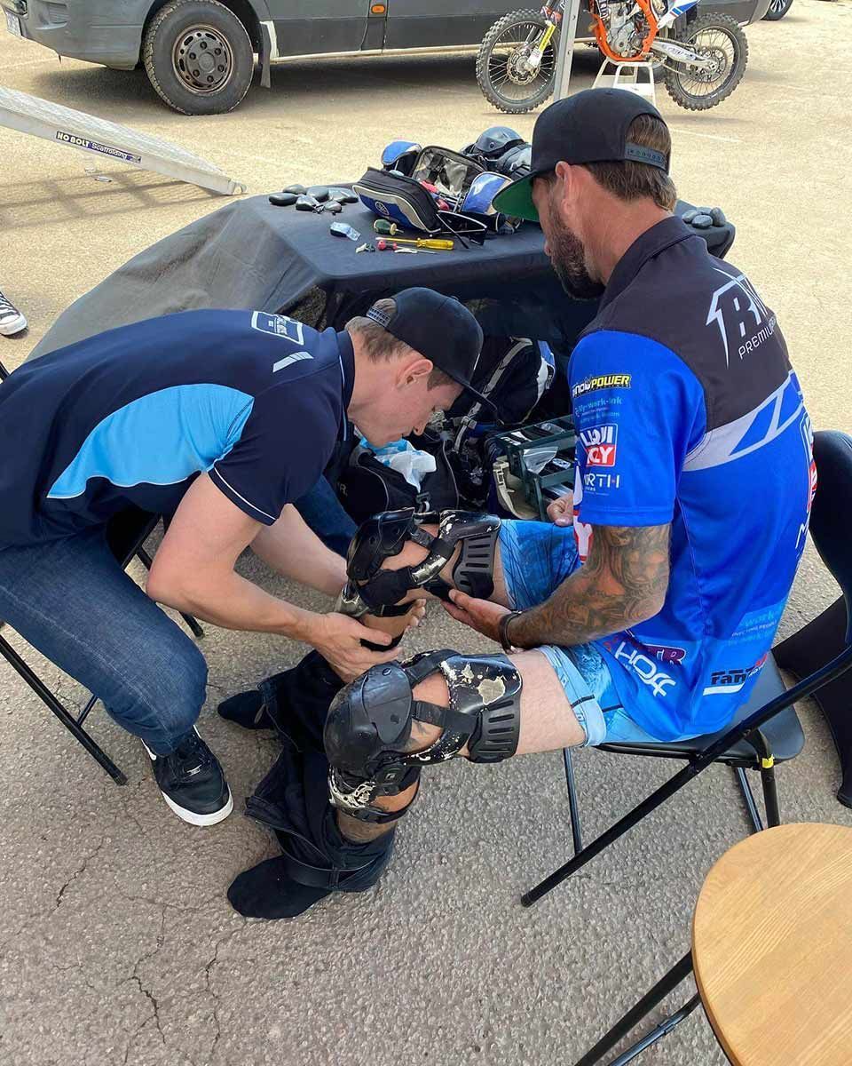 Two Men Are Working on a Person 's Knee Pads — Gall Bros Medical in Perth, WA