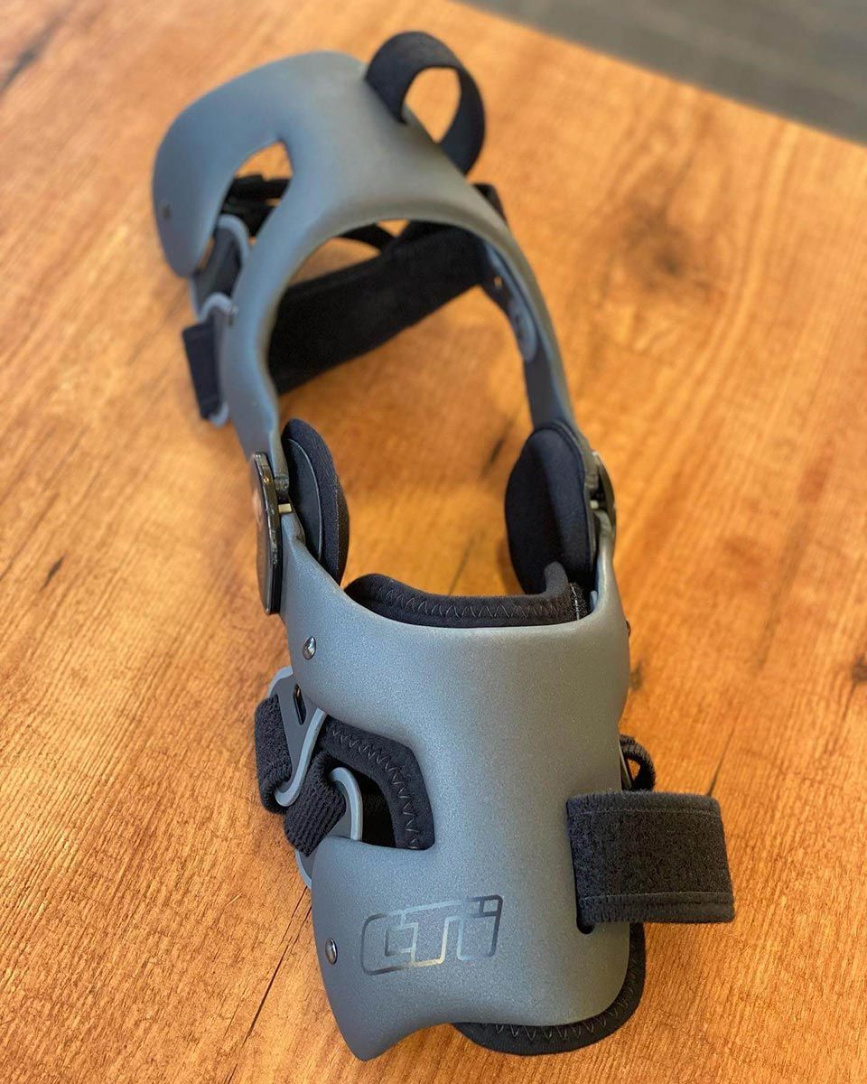 A Gray and Black Knee Brace — Gall Bros Medical in Robina, QLD