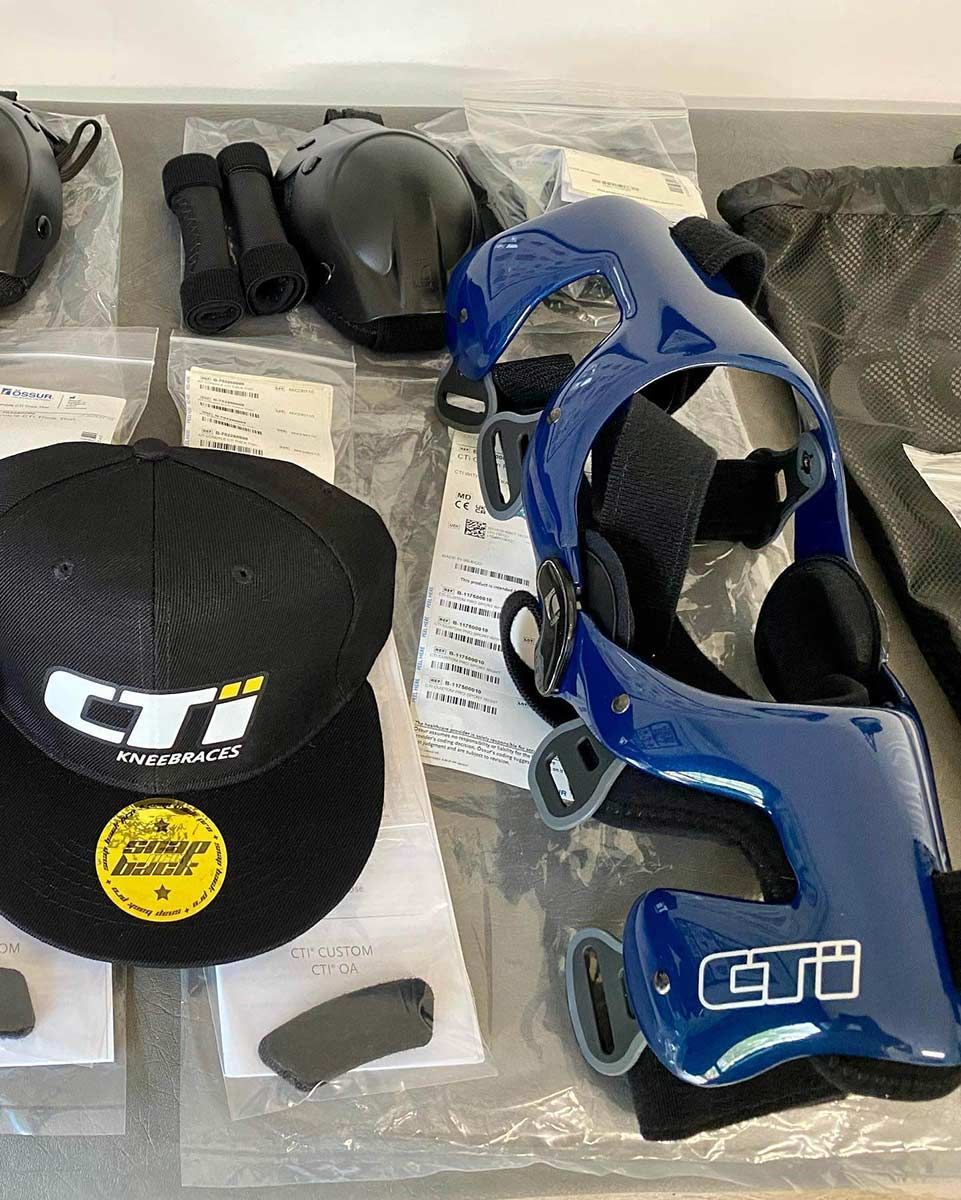 A Black Hat and a Blue Helmet Are on a Table — Gall Bros Medical in Melbourne, VIC