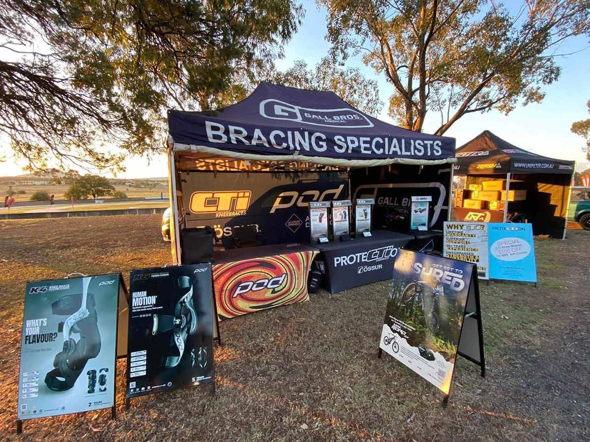A Bracing Specialists Tent is Sitting in the Middle of a Dirt Field — Gall Bros Medical in Perth, WA