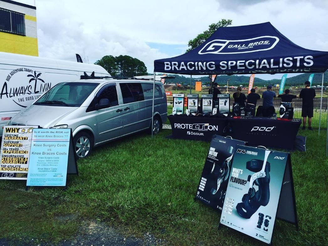 A Silver Van and a Display Tent for at an Outdoor Event — Gall Bros Medical in Robina, QLD