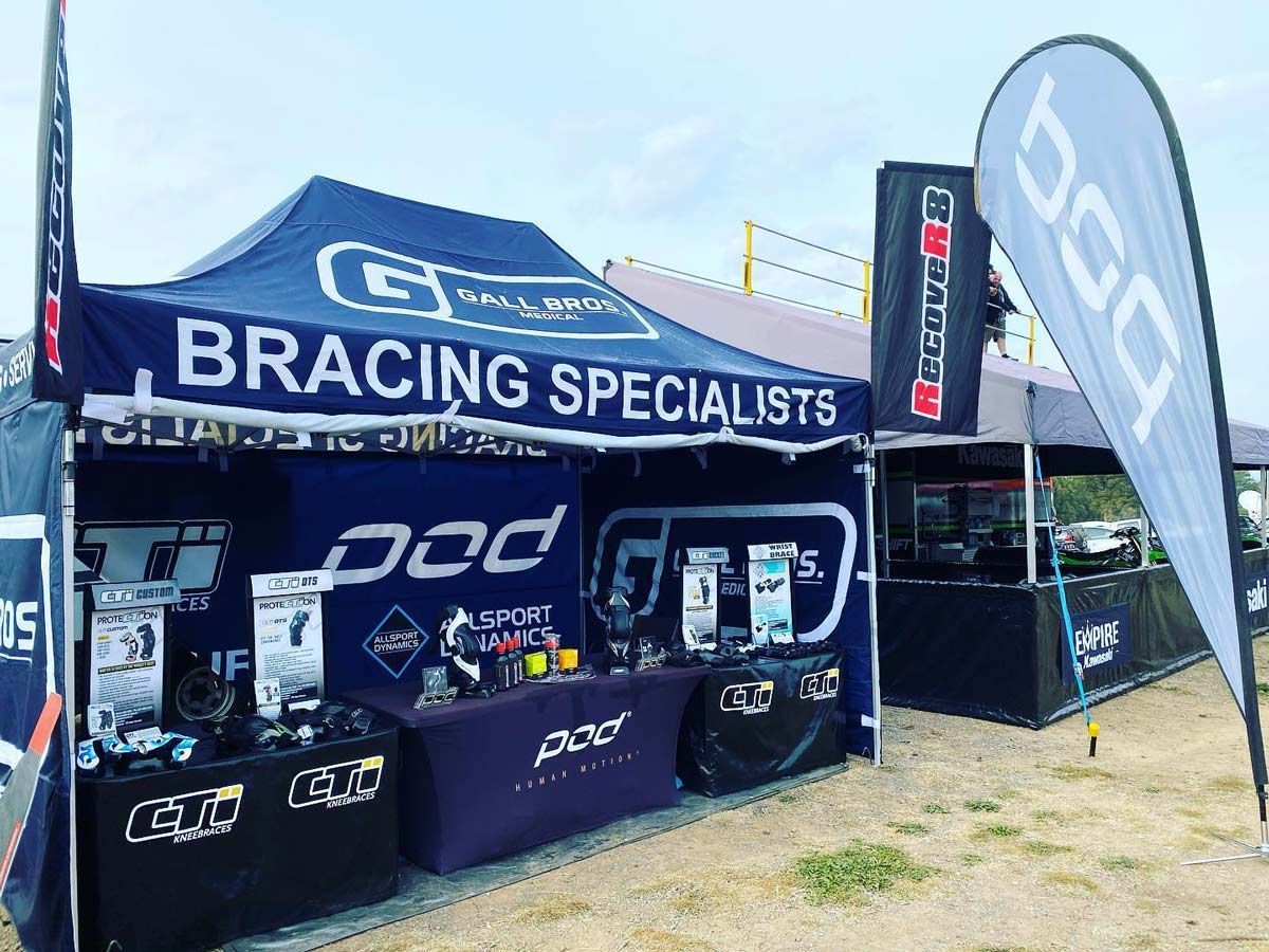 A Bracing Specialists Tent is Sitting in the Middle of a Field — Gall Bros Medical in Robina, QLD