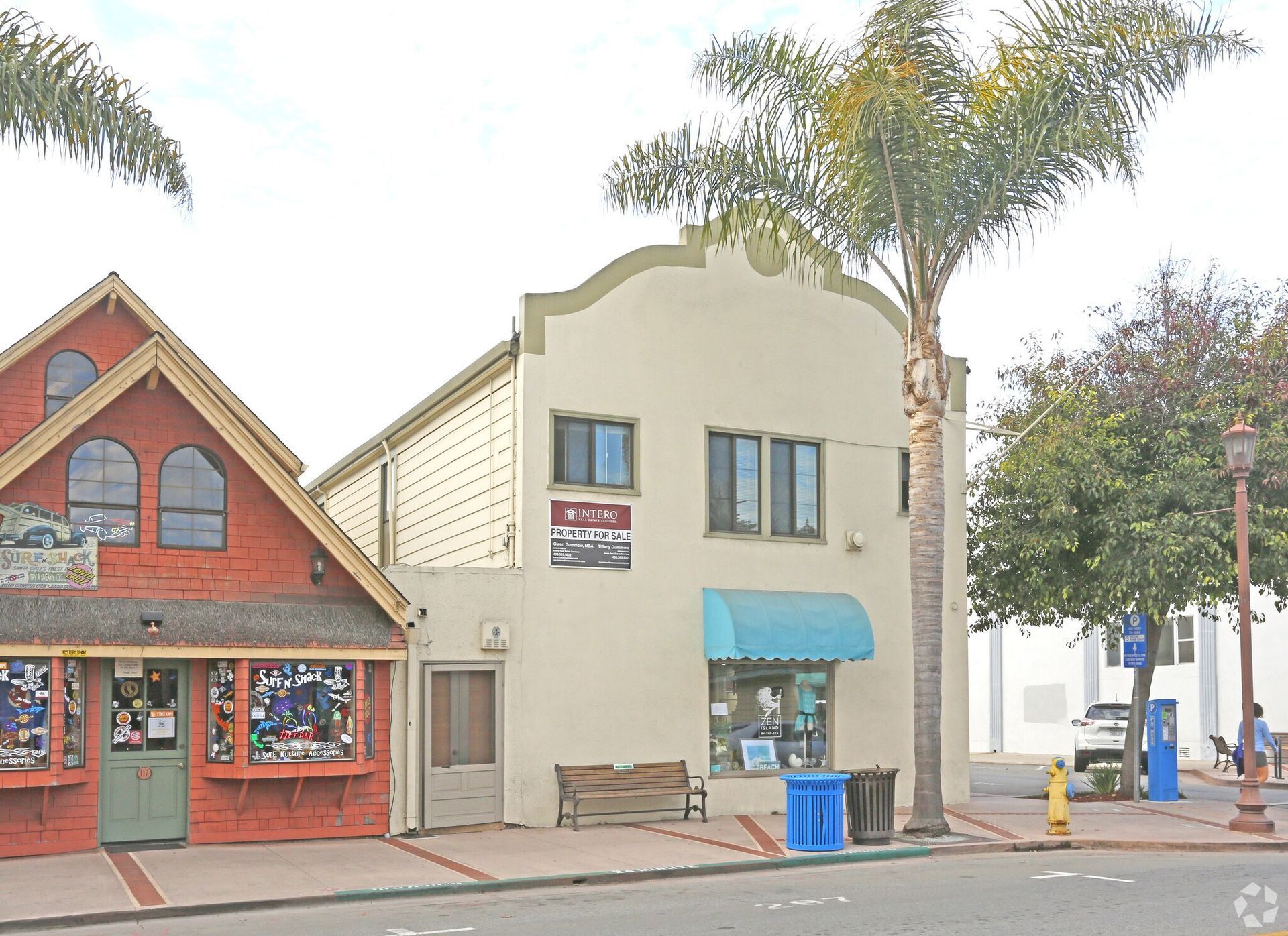 Modern multi-story apartment buildings with balconies against a clear blue sky.