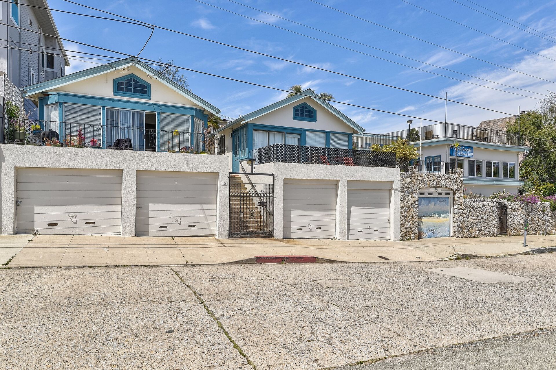 Modern home built from shipping containers with a small yard.