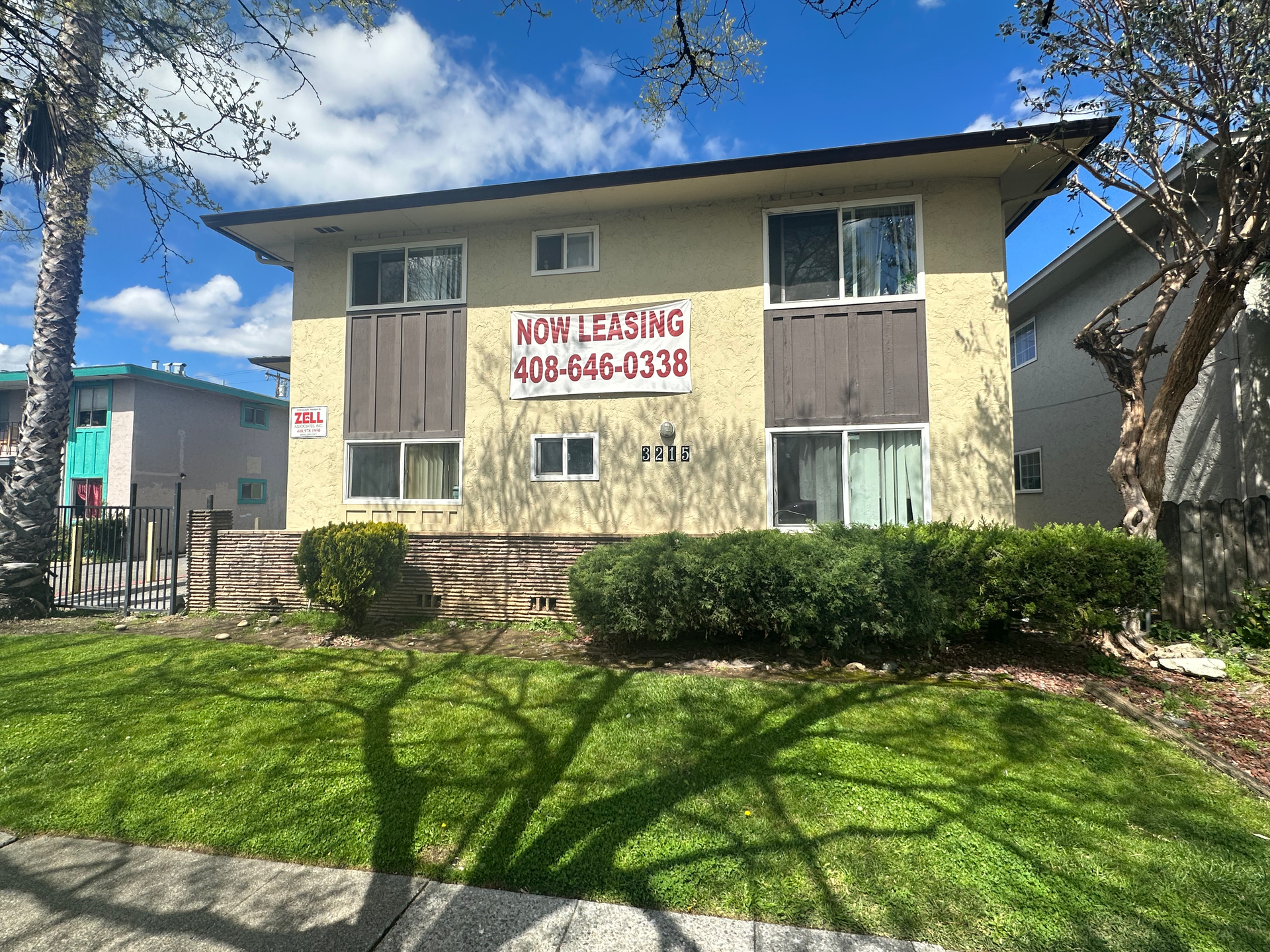 Modern home built from shipping containers with a small yard.