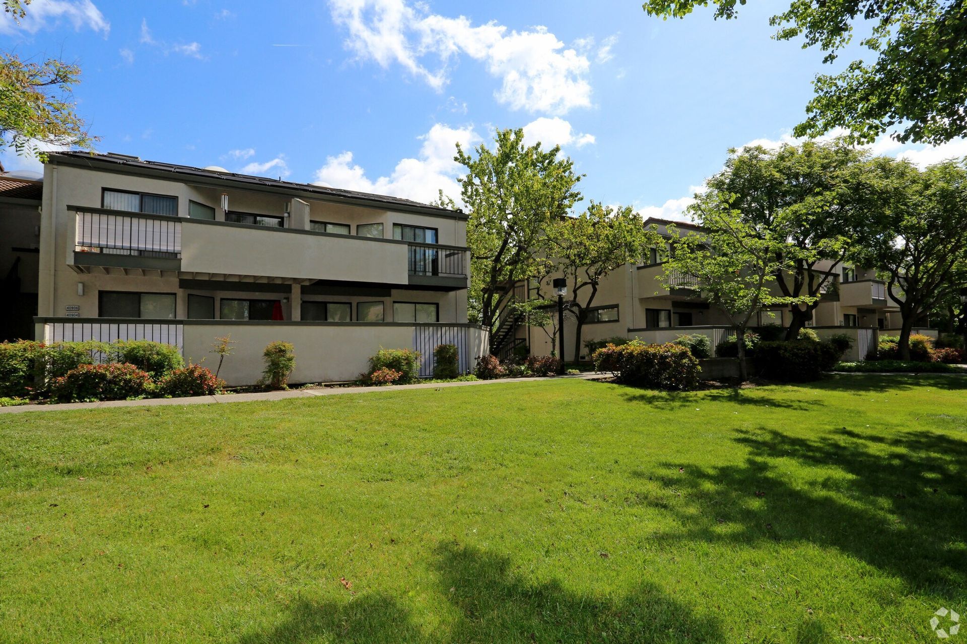 Modern home built from shipping containers with a small yard.