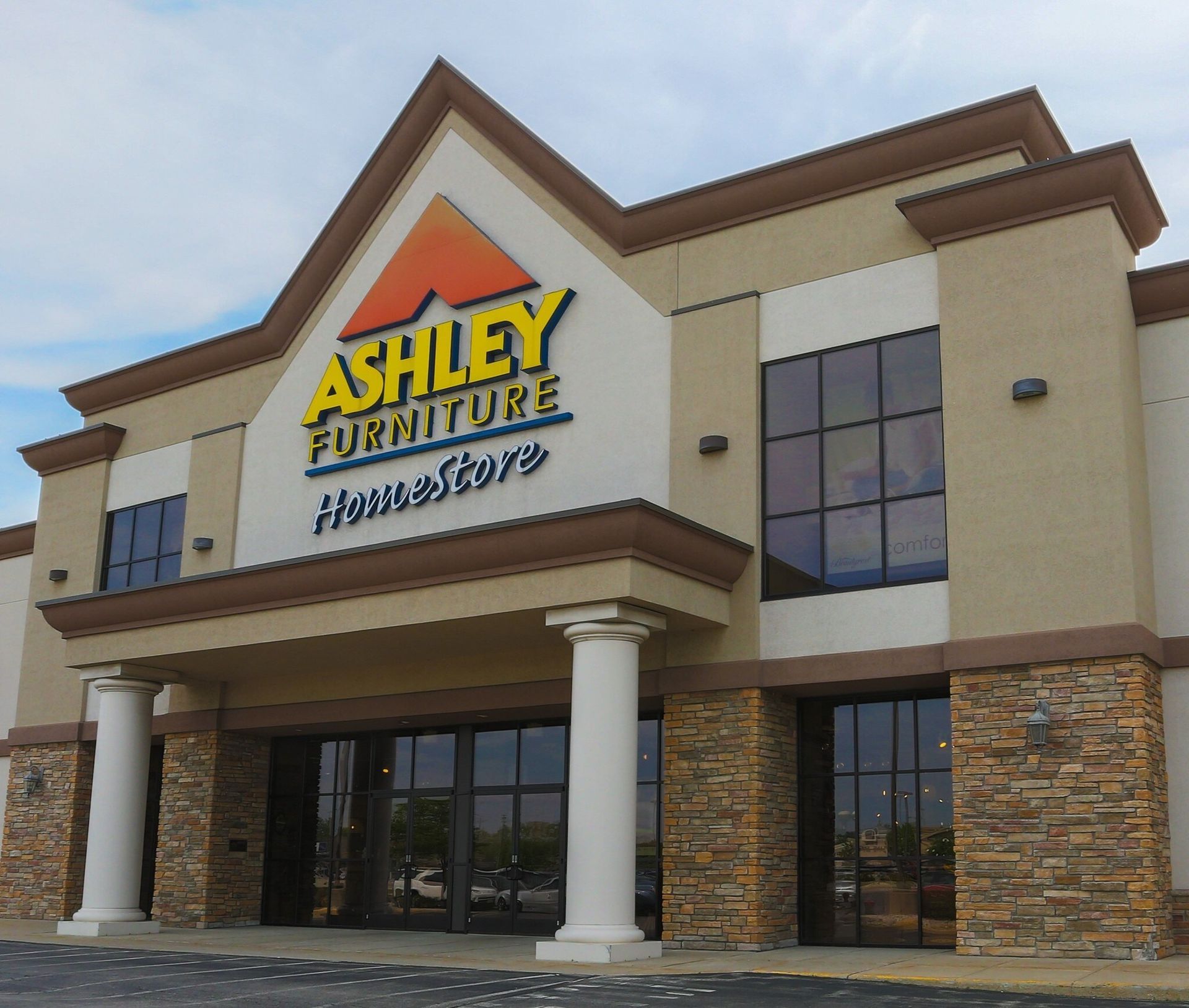 Modern home built from shipping containers with a small yard.