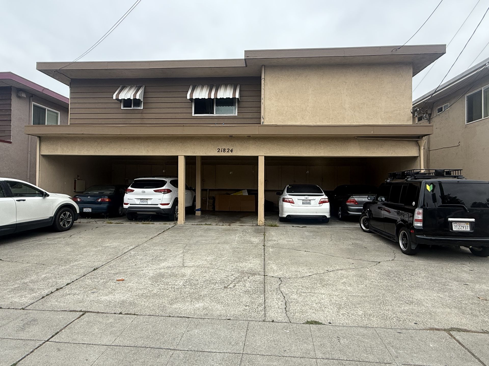 Man in gray suit and blue shirt smiles, headshot against a gray backdrop.