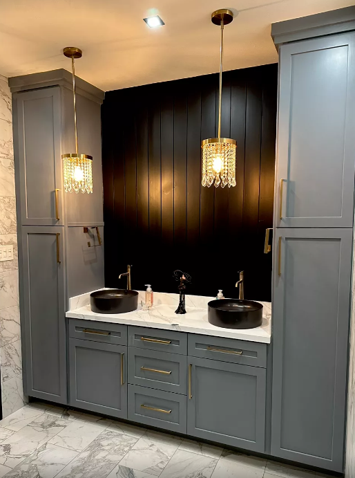 A bathroom with two sinks and a black wall.