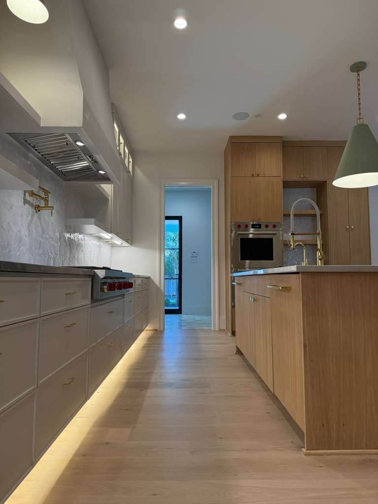 A laundry room with a washer and dryer and sliding barn doors.
