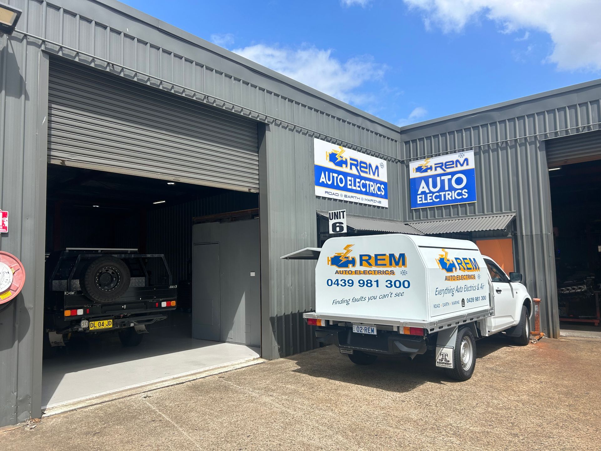 A Person Is Using A Multimeter To Test A Circuit Board — REM Auto Electrics In Cardiff, NSW