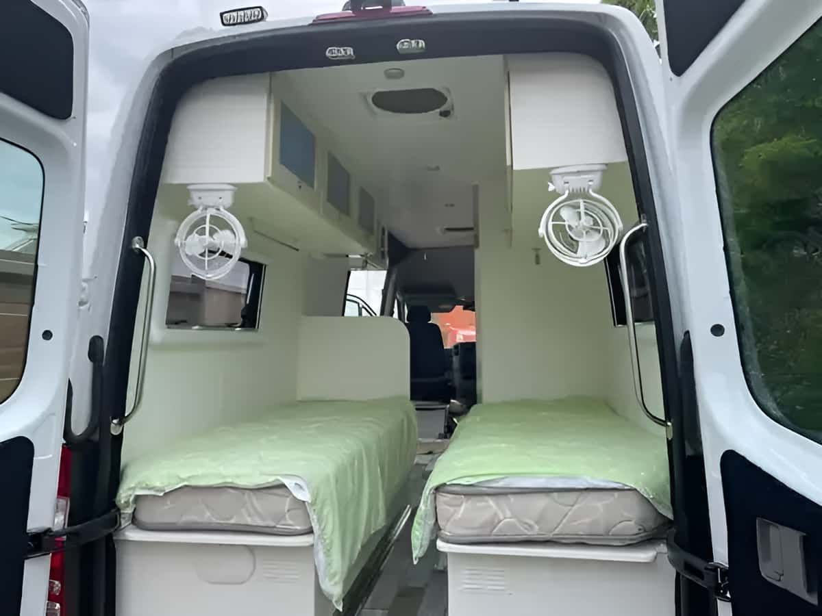The Back Of A White Van With Two Beds And Two Fans — REM Auto Electrics In Newcastle, NSW