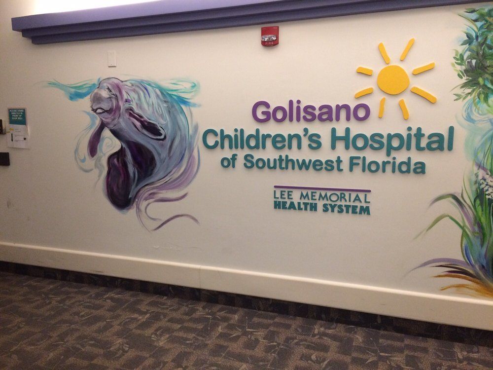 a wall with a painting of a manatee and the words golisamo children 's hospital of southwest florida