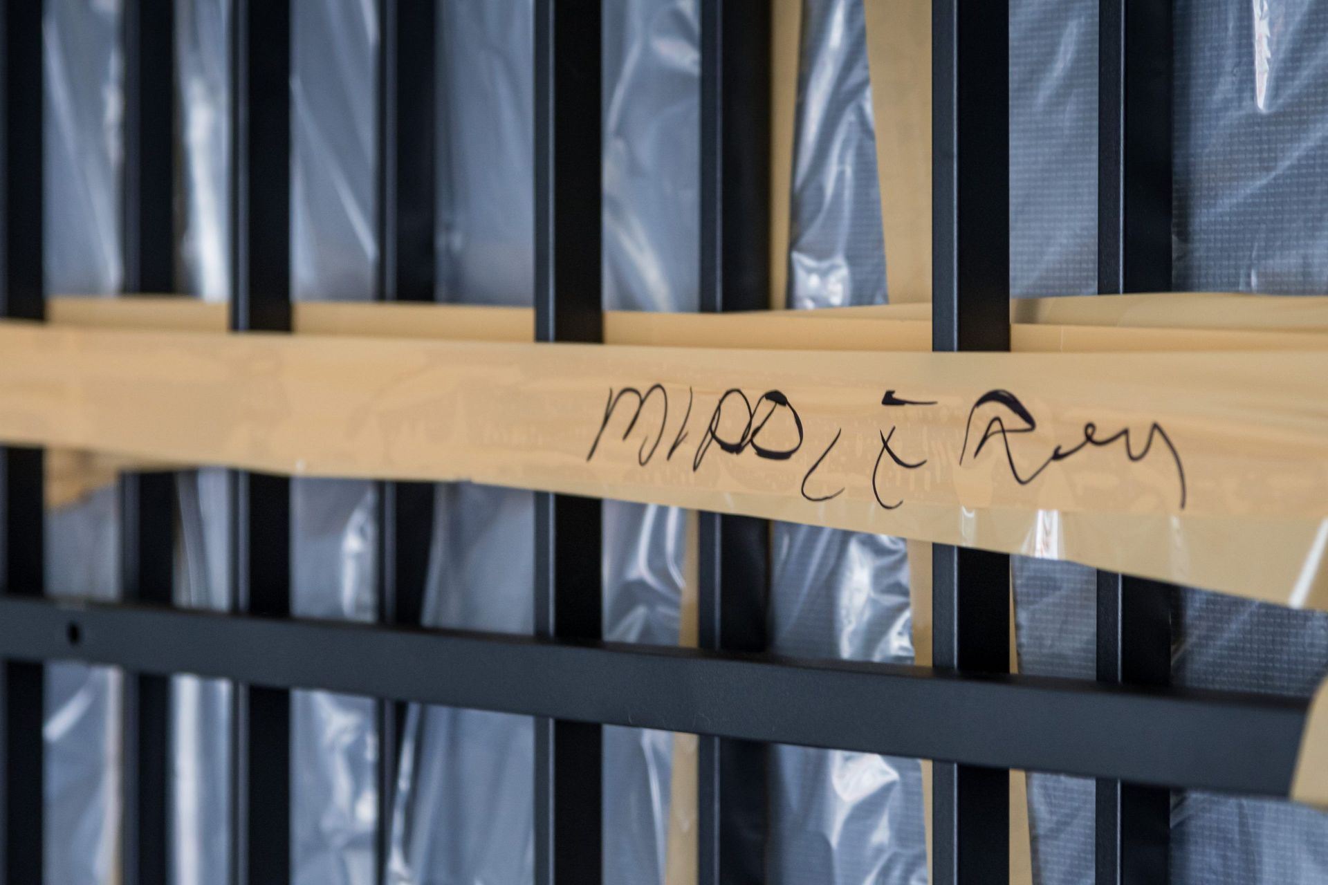 A prison cell with a wooden plank between the bars that says midterm