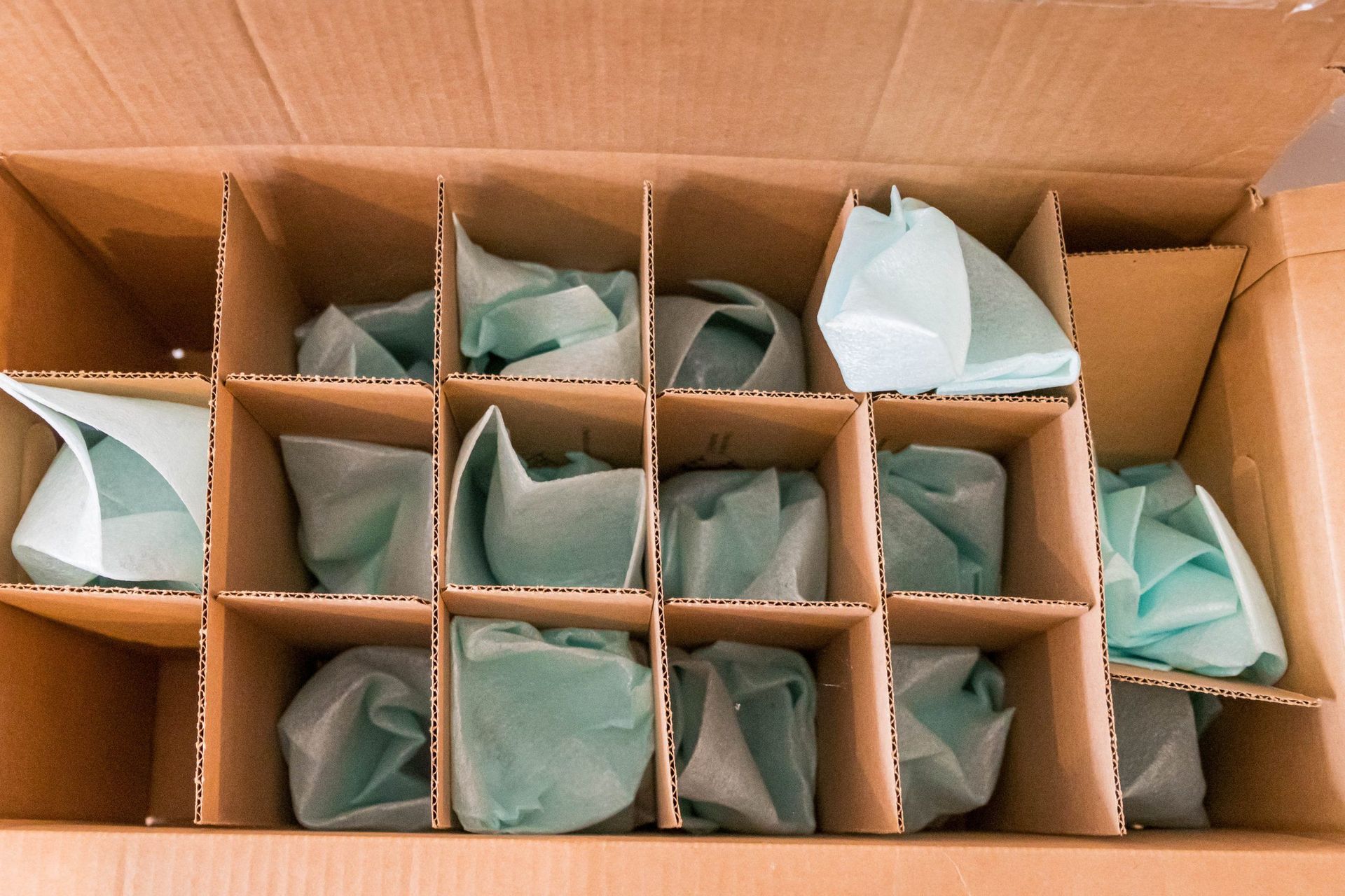 A cardboard box filled with lots of wrapped items