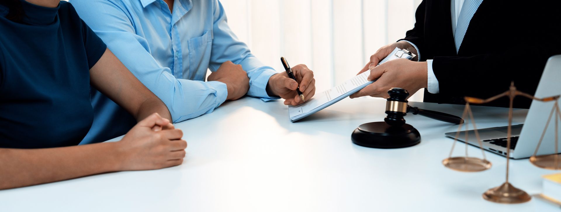 Couple signing documents with a lawyer