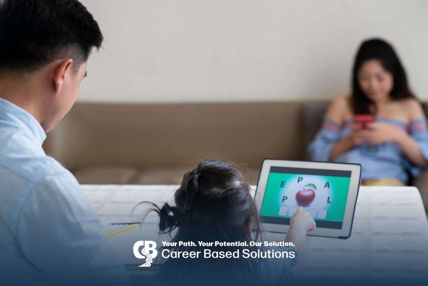 Autistic kid uses a tablet with a parent to practice communication and learning during ABA therapy