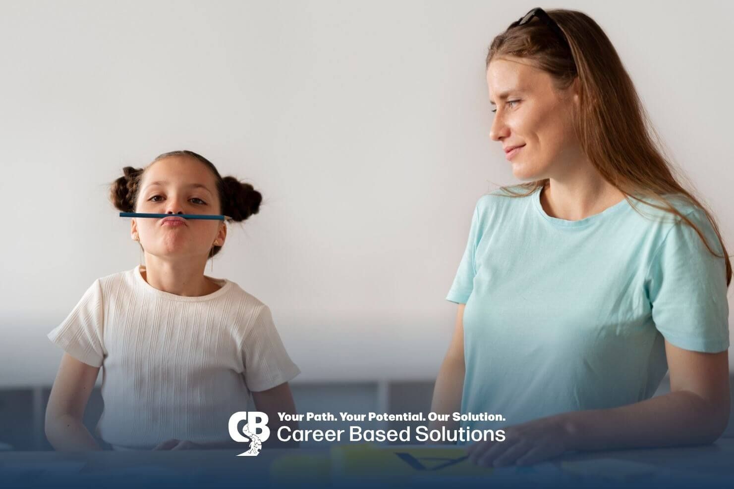 Autistic girl balancing a pencil on her upper lip while a therapist watches during ABA session.