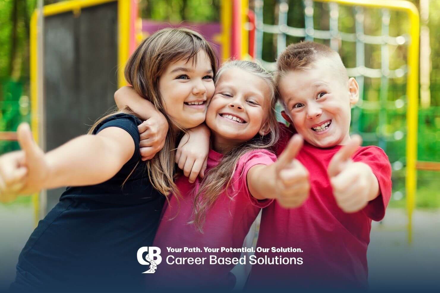 Three autistic children hugging and giving thumbs up while standing together on a playground.