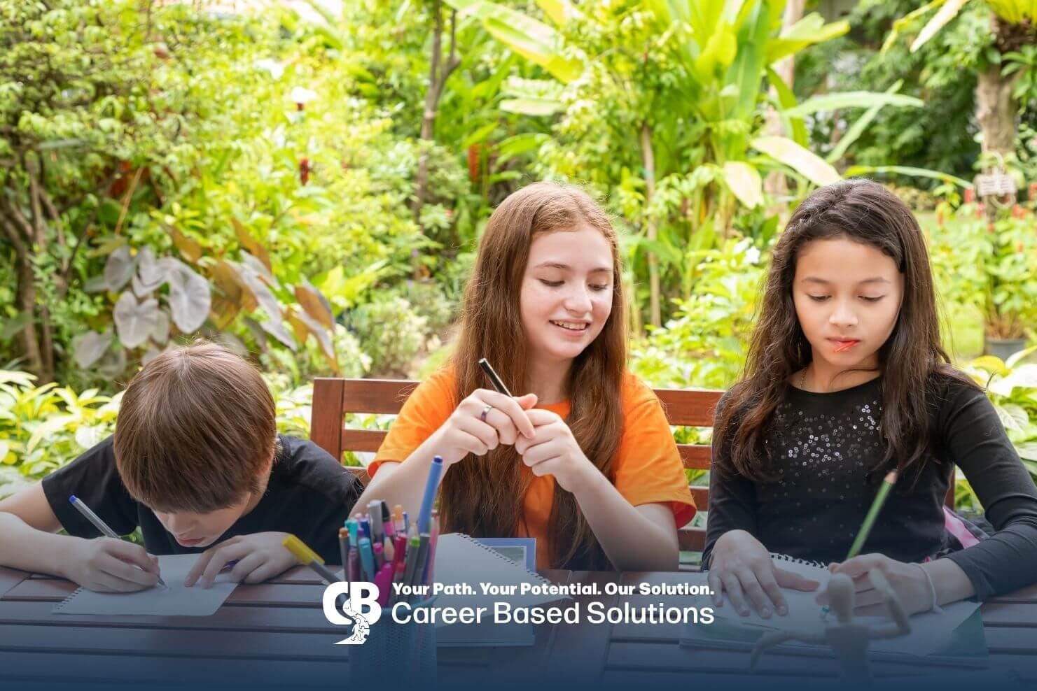 Autistic kids participating in an outdoor learning activity drawing & writing together after therapy