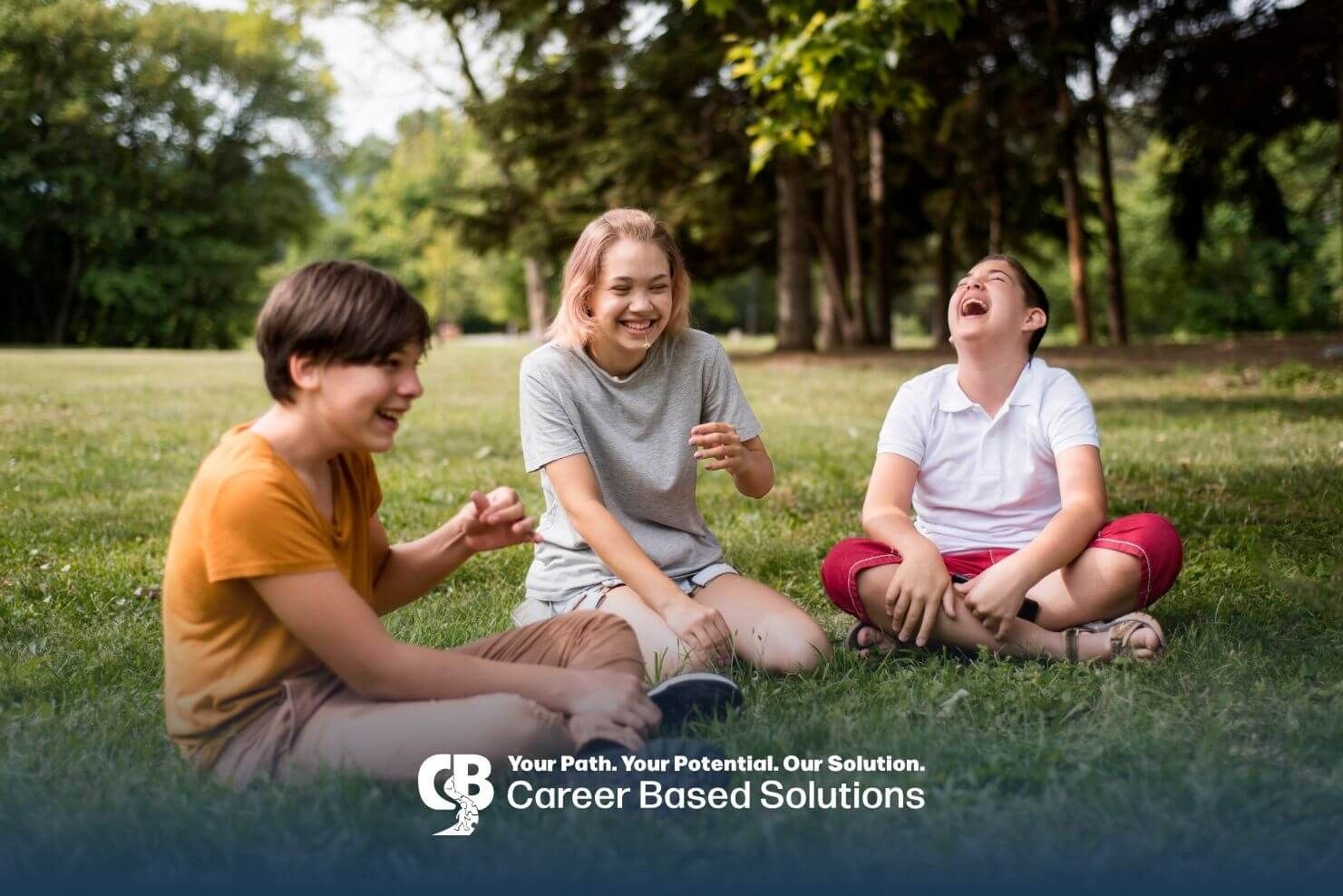 Autistic kids sitting in a park laughing together, demonstrating therapy improving social skills.