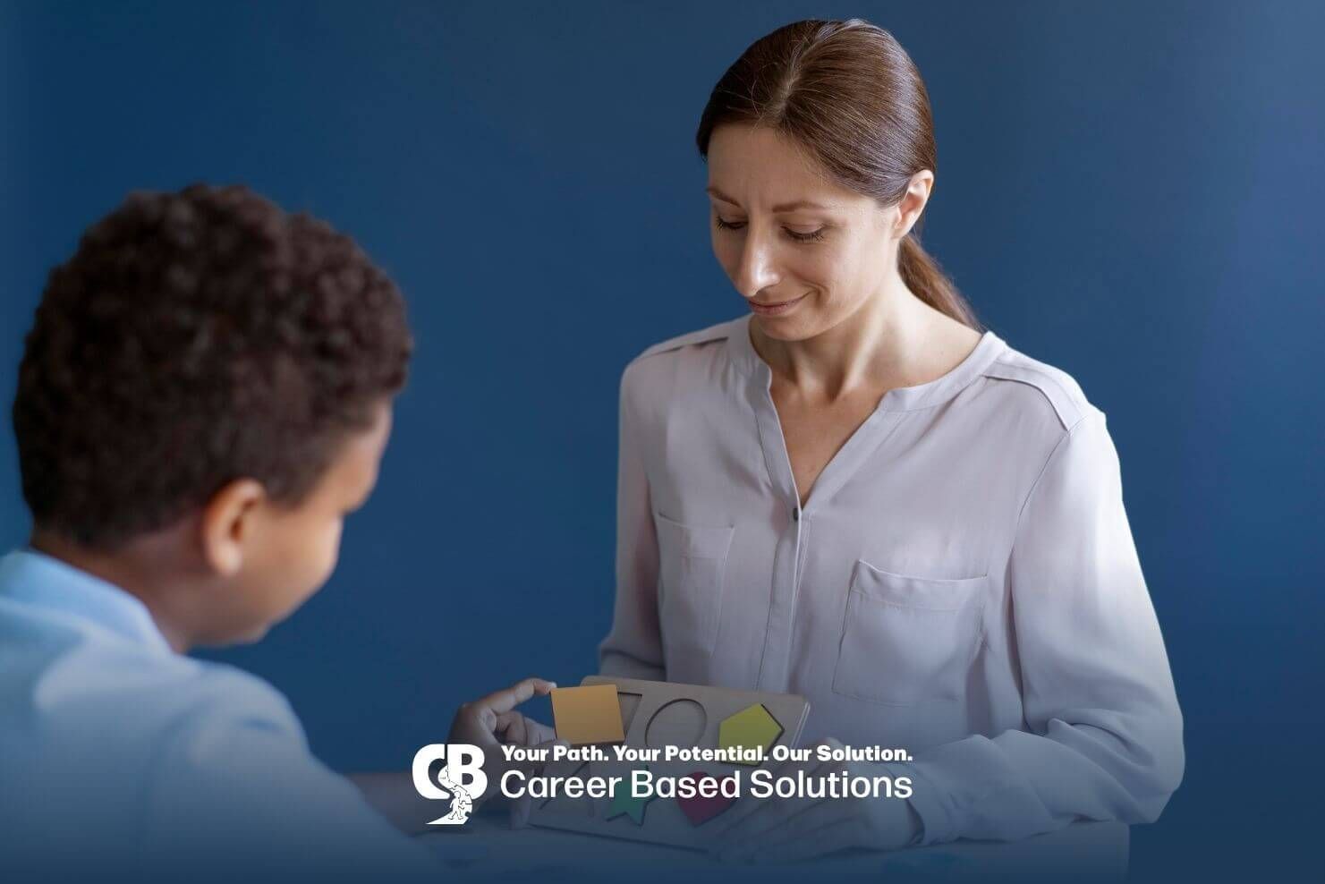 Therapist helping an autistic boy place colorful shapes into a wooden puzzle board during therapy.