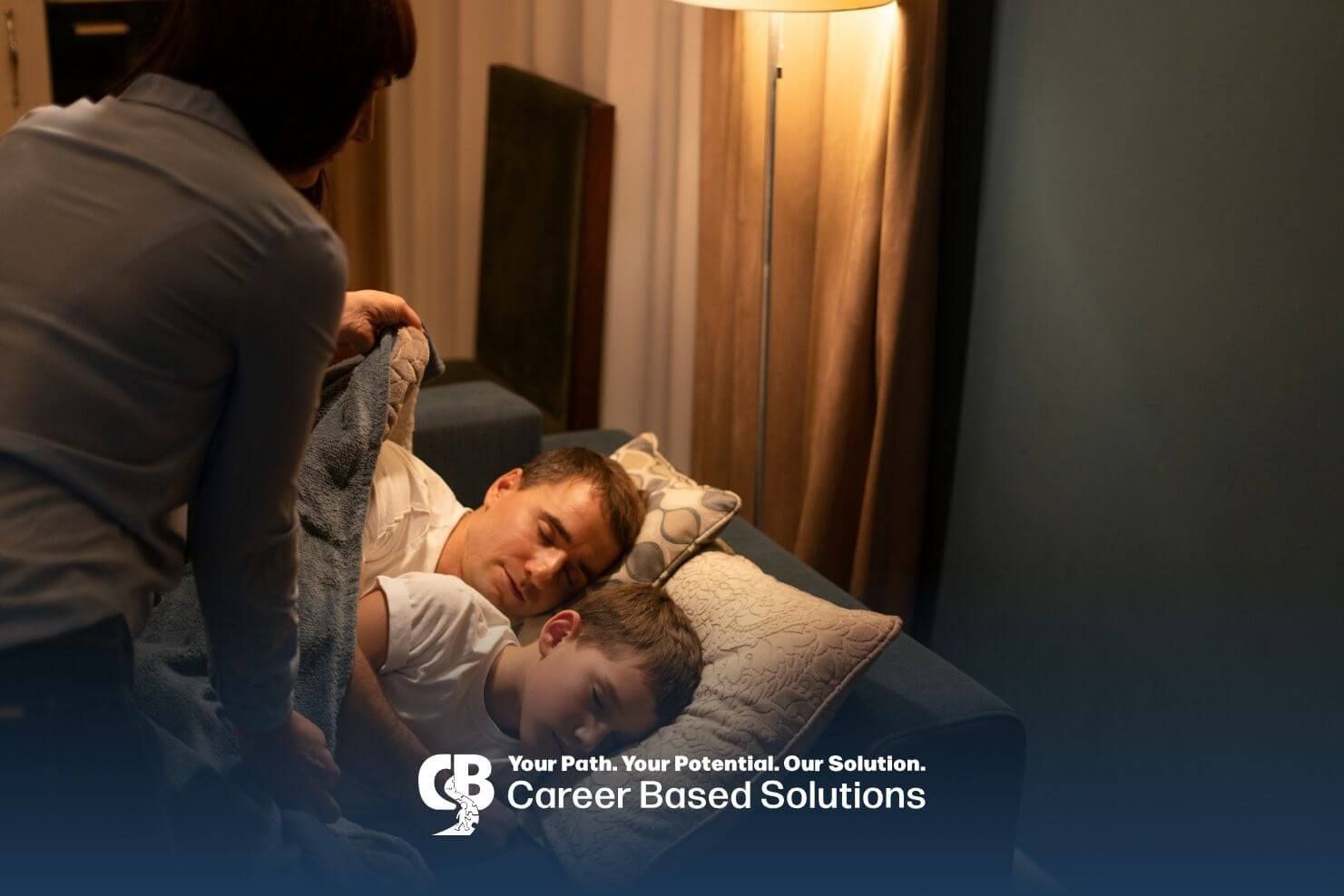 Therapist tucks a sleeping autistic boy under a blanket while another therapist rests beside them 