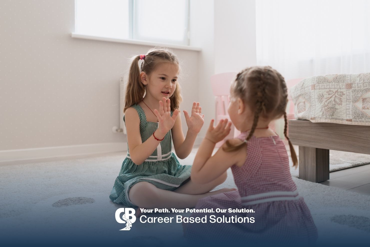 Two autistic young girls playing hands with a cheerful smiles during ABA therapy in Virginia