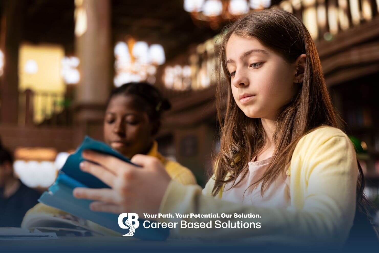 Autistic students reading from a tablet in a library setting, highlighting educational support