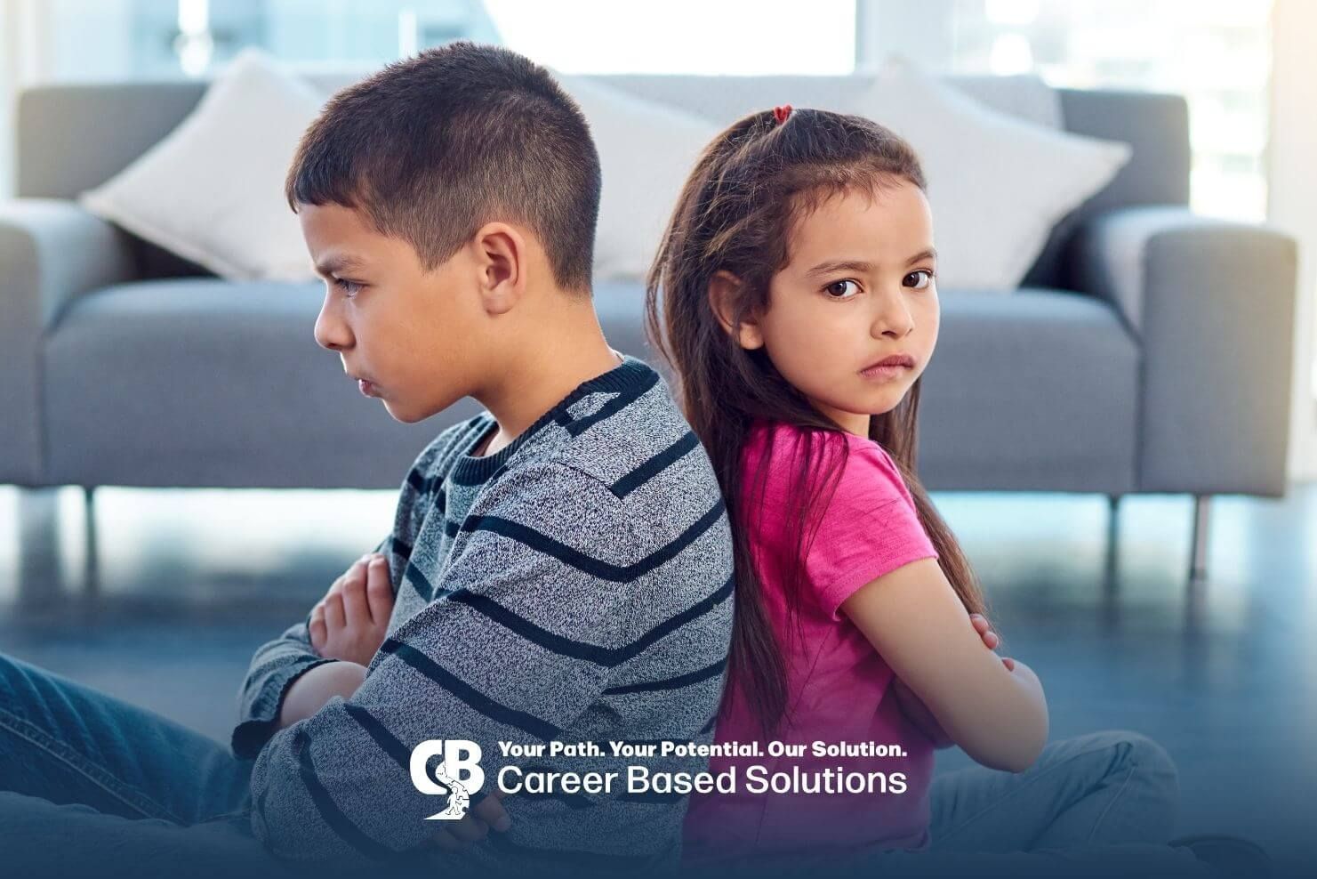 Two autistic kids are sitting back to back, facing away from each other and crossing their arms.