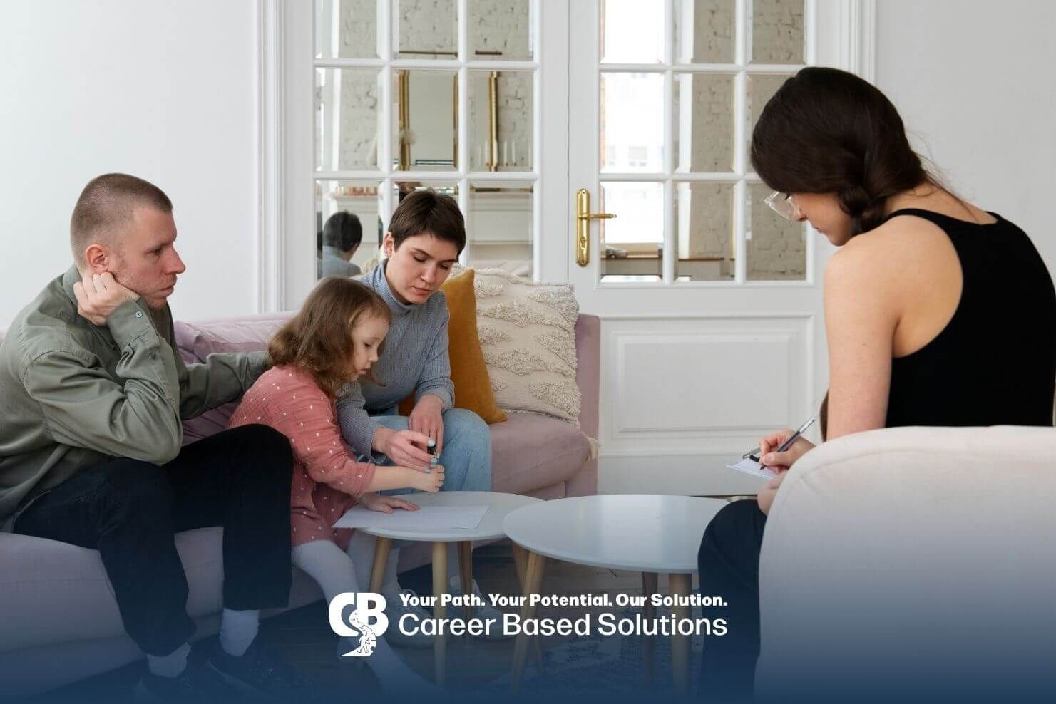 Meeting with therapist during in-home ABA, parents observing autistic girl completing activity
