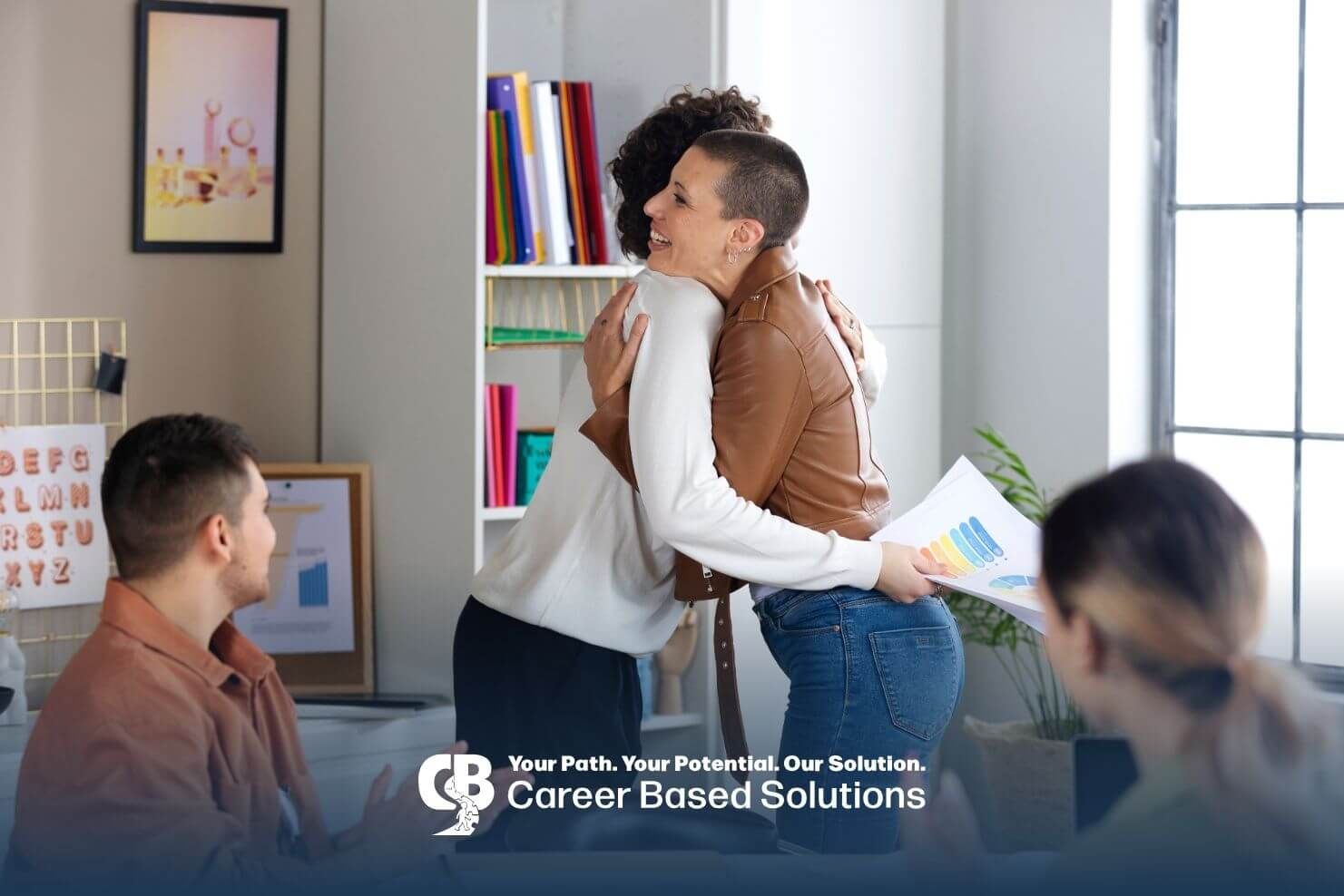 A team of therapists with hug in office, highlighting support & teamwork in behavior technician