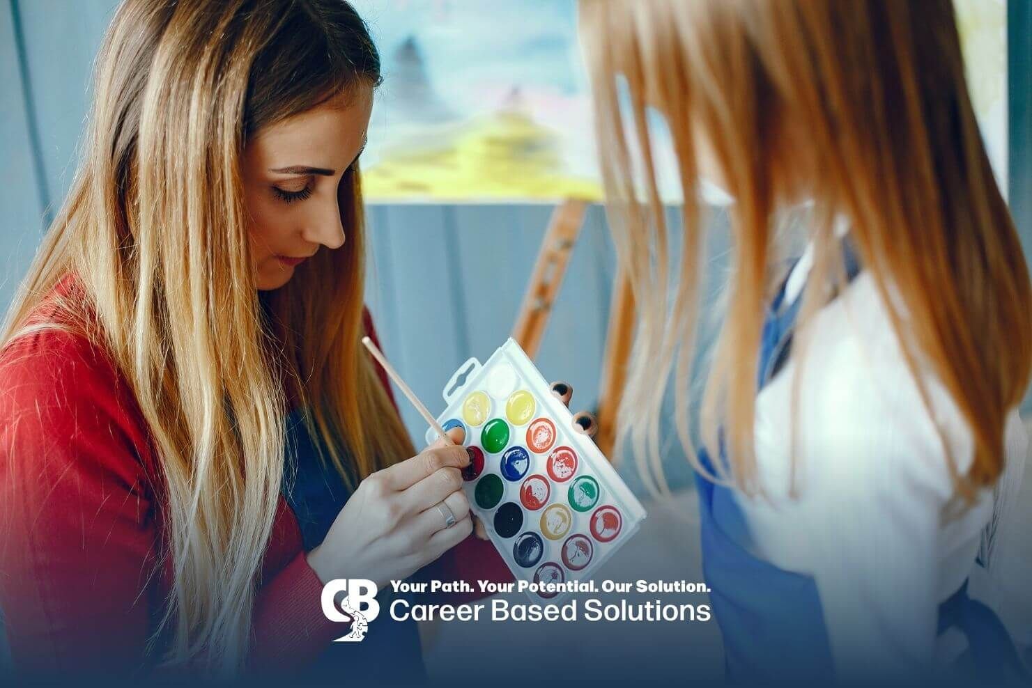 Therapist and autistic girl painting with watercolor palette, promoting sensory play and creativity