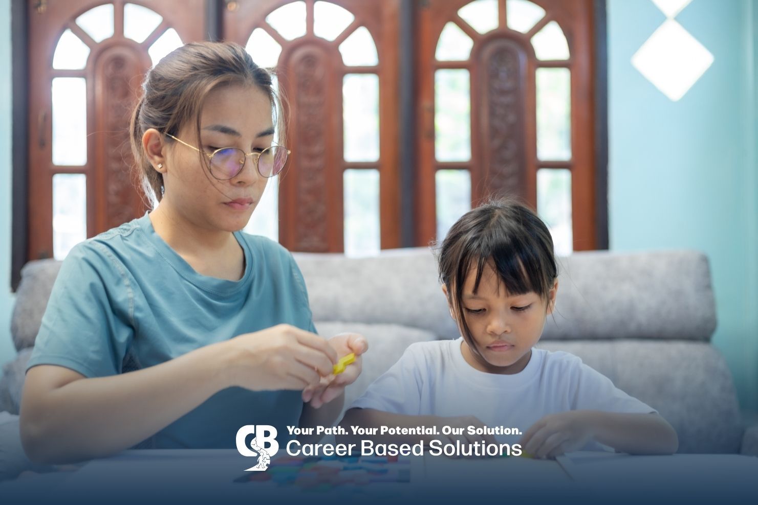Parent and child use colorful learning pieces together in a structured educational activity at home.
