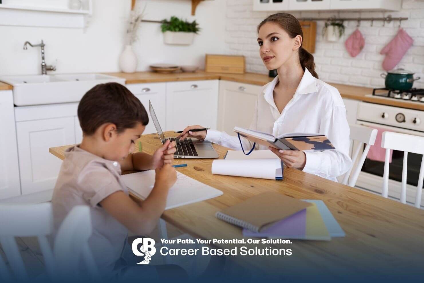 Therapist helps autistic boy with schoolwork at kitchen table, supporting ABA therapy and learning.