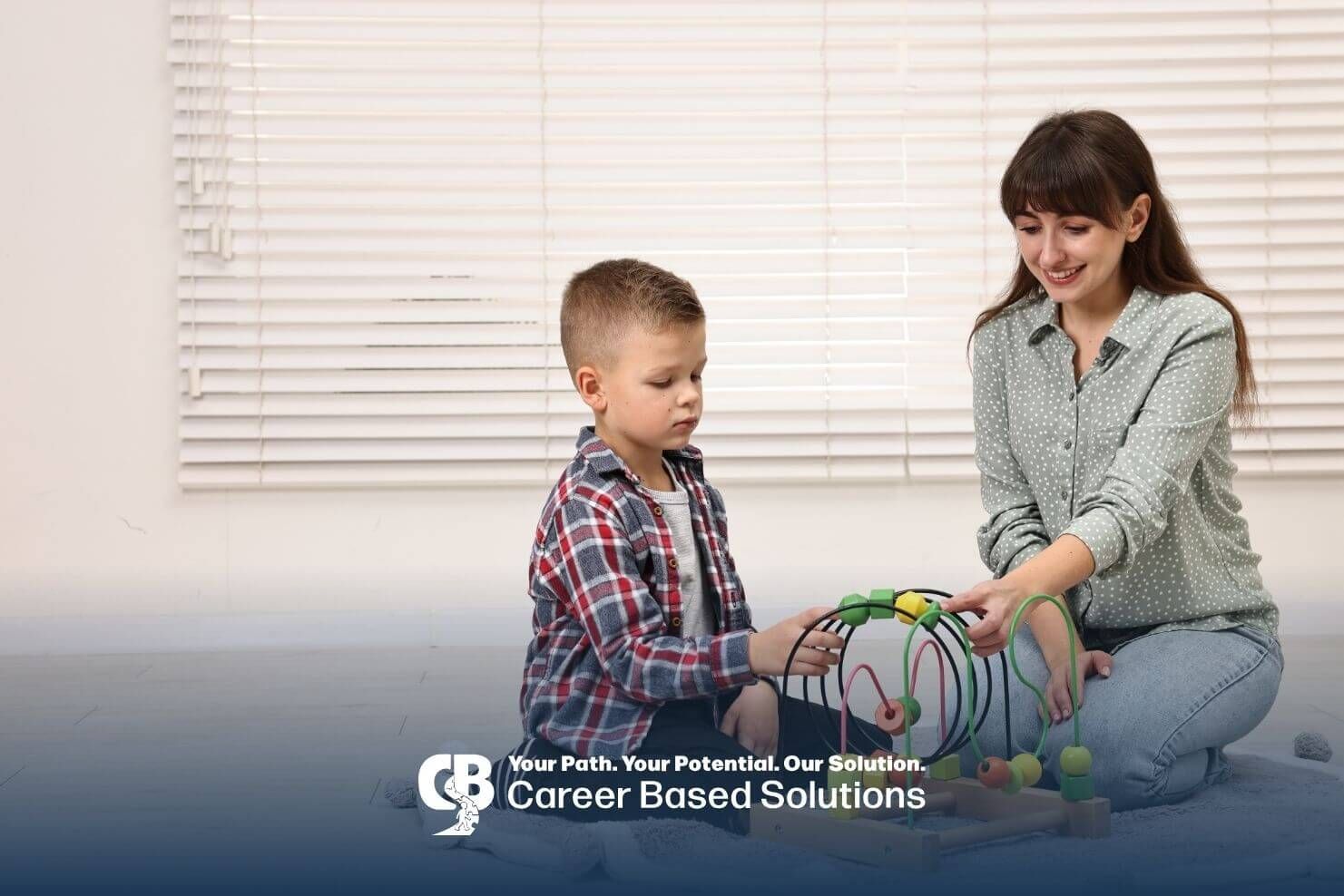 Therapist & autistic boy using a bead maze toy during an interactive ABA learning session indoors